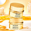 Two skincare containers with a white background