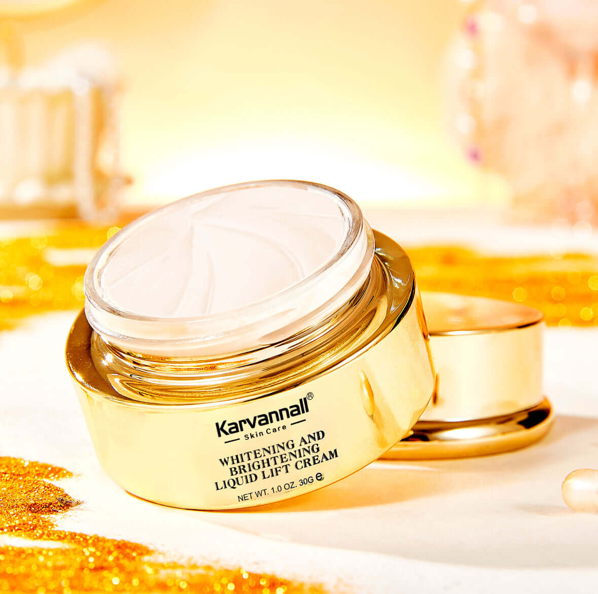 Gold jar of Karvamall Whitening and Brightening Liquid Lift Cream on a blurred background