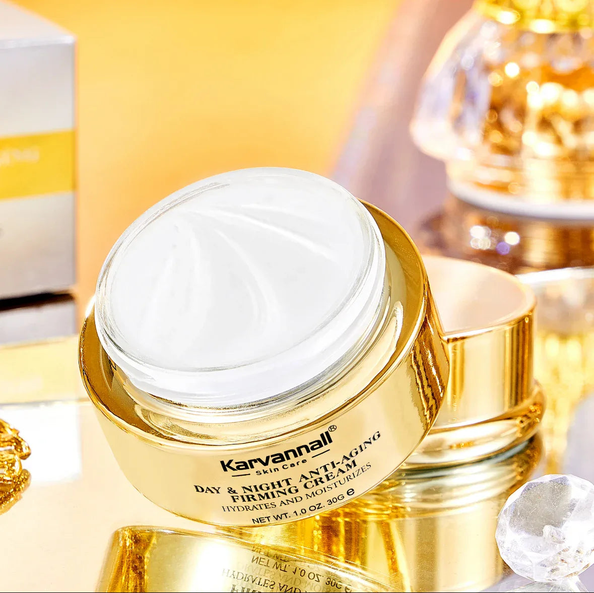 Gold skincare jar with white cream on a reflective surface